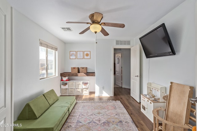 living room with dark hardwood / wood-style floors and ceiling fan