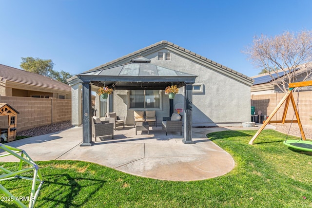 back of property with a gazebo, a lawn, an outdoor hangout area, a playground, and a patio