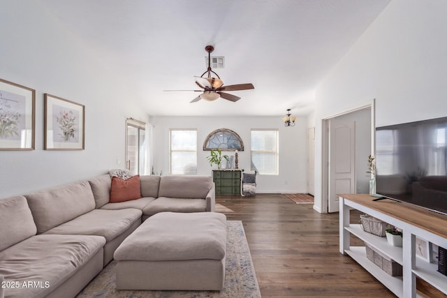 living room with dark hardwood / wood-style flooring, vaulted ceiling, and ceiling fan