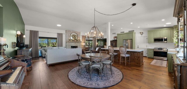 8049 E Serene St, Carefree, AZ 85377 - dining space featuring a fireplace, dark wood-style floors, recessed lighting, and a chandelier