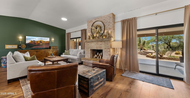 8049 E Serene St, Carefree, AZ 85377 - living area with vaulted ceiling, plenty of natural light, wood finished floors, and a fireplace