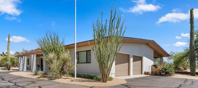 8049 E Serene St, Carefree, AZ 85377 - view of front of home with a garage, a pergola, and stucco siding