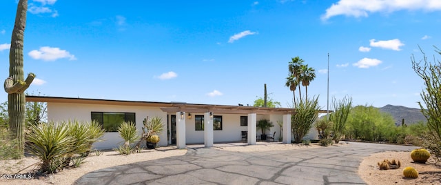 8049 E Serene St, Carefree, AZ 85377 - view of front of house with stucco siding, a mountain view, a pergola, and a patio area