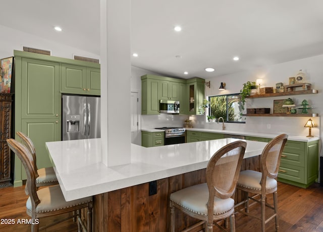 8049 E Serene St, Carefree, AZ 85377 - kitchen featuring stainless steel appliances, green cabinets, open shelves, a kitchen breakfast bar, and dark wood finished floors