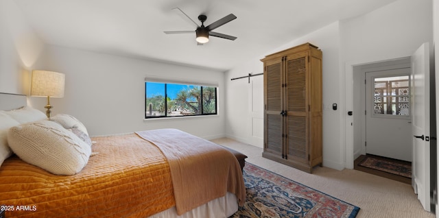 8049 E Serene St, Carefree, AZ 85377 - bedroom with light colored carpet, a barn door, a ceiling fan, and lofted ceiling