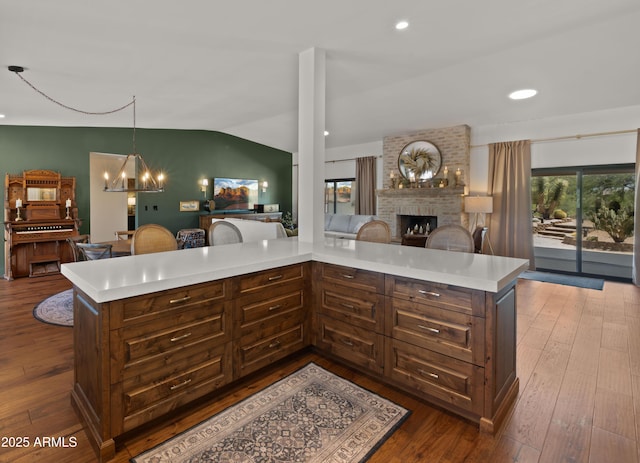 8049 E Serene St, Carefree, AZ 85377 - kitchen with a brick fireplace, light countertops, open floor plan, lofted ceiling, and dark wood-style floors