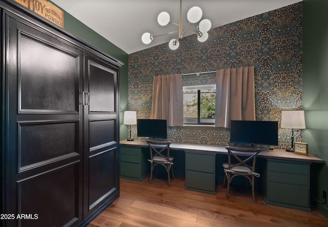 8049 E Serene St, Carefree, AZ 85377 - office area featuring built in study area, wallpapered walls, wood finished floors, and a chandelier