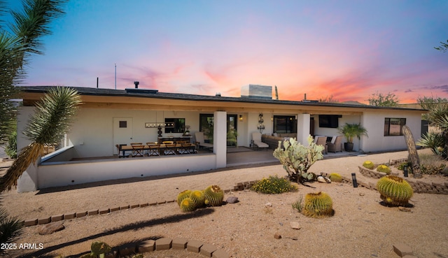 8049 E Serene St, Carefree, AZ 85377 - back of house at dusk with stucco siding