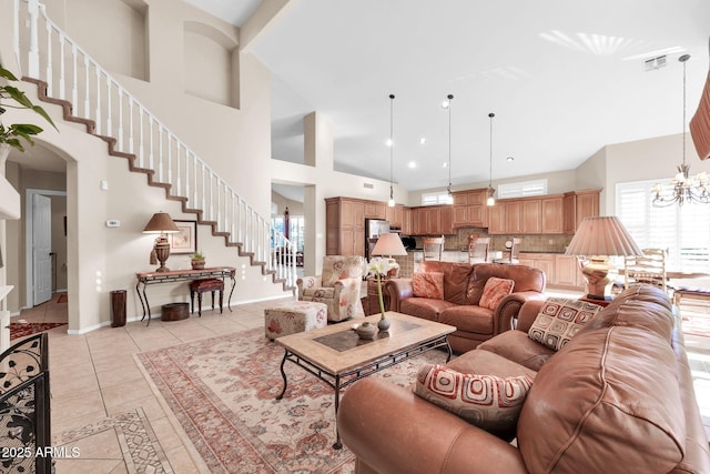 living room featuring a towering ceiling, light tile patterned flooring, and an inviting chandelier