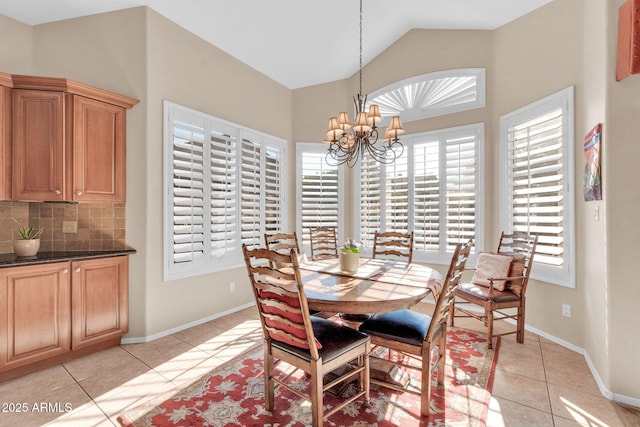 dining room with light tile patterned floors, lofted ceiling, and a notable chandelier