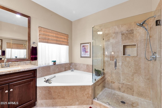 bathroom featuring plus walk in shower and vanity