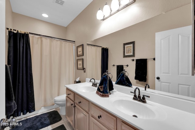 bathroom featuring toilet, vanity, and tile patterned floors