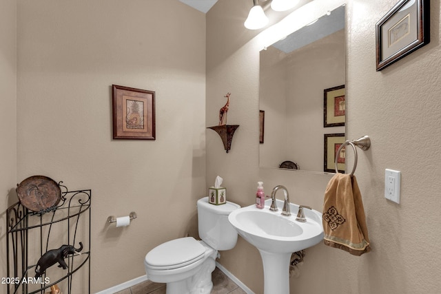 bathroom with tile patterned flooring and toilet