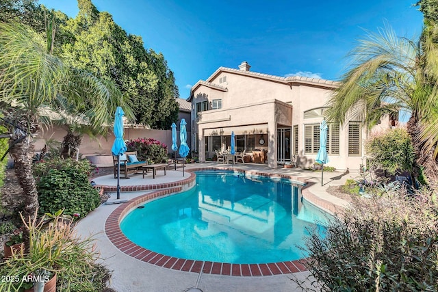 view of swimming pool with a patio area