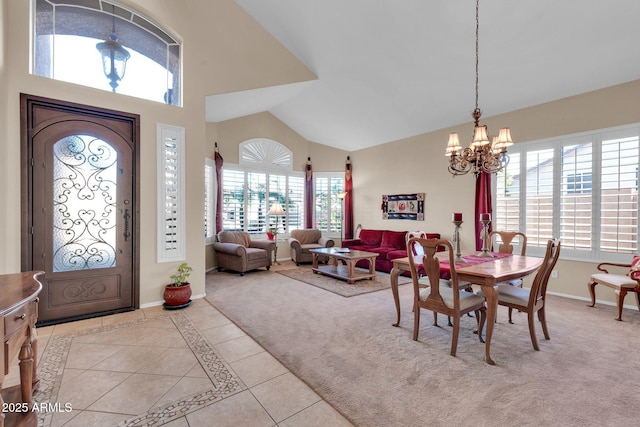 carpeted dining space with plenty of natural light and an inviting chandelier