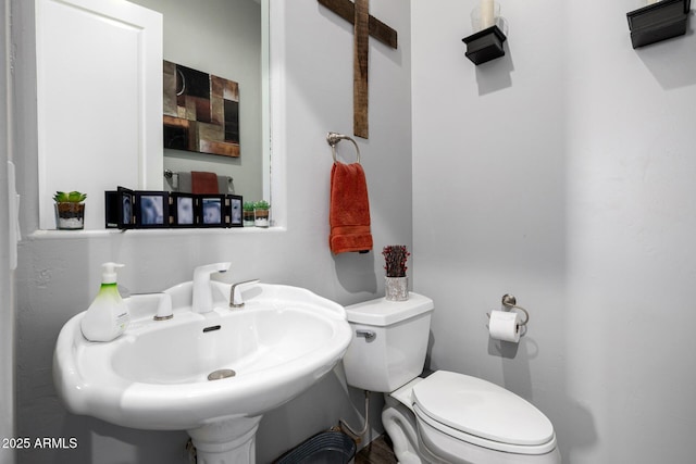 half bathroom with a sink and toilet