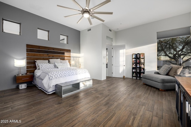 bedroom featuring ceiling fan, dark wood finished floors, and visible vents