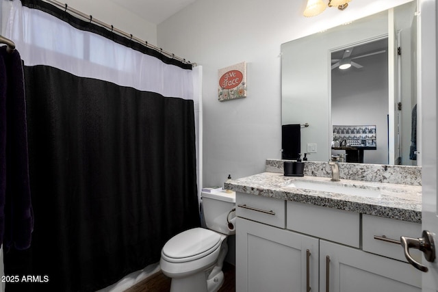 bathroom featuring a shower with shower curtain, vanity, and toilet