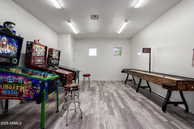 recreation room featuring visible vents and wood finished floors