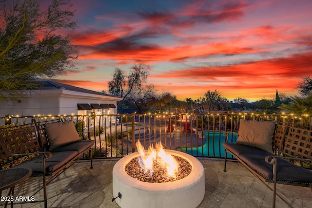 view of patio featuring an outdoor fire pit and an outdoor pool