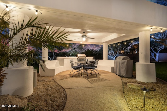 view of patio featuring exterior kitchen, outdoor dining area, grilling area, and a ceiling fan