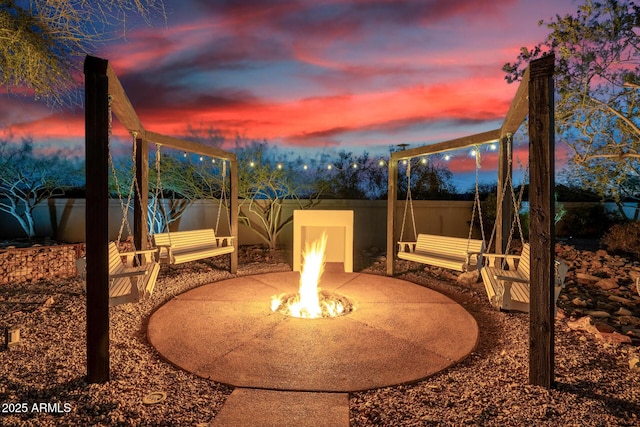 view of patio featuring an outdoor fire pit and a fenced backyard