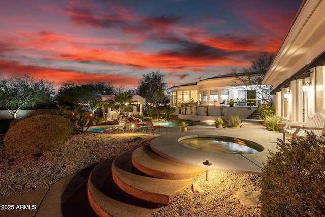 exterior space with a patio, stairway, and an in ground hot tub