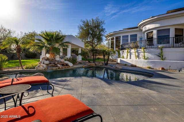 pool with a patio and fence