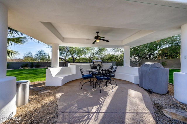 view of patio with ceiling fan, outdoor dining area, area for grilling, and a fenced backyard