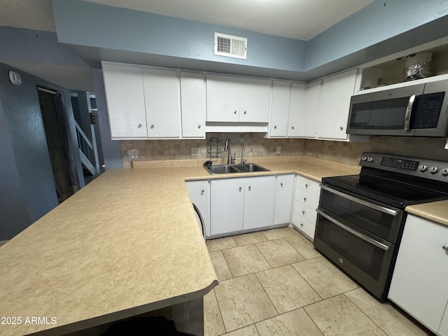 5363 N Black Canyon Highway, Phoenix, AZ 85015 - kitchen featuring visible vents, stainless steel microwave, a sink, range with two ovens, and backsplash