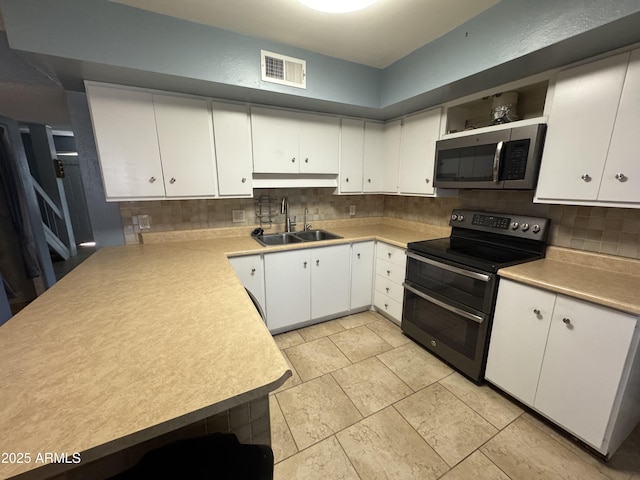5363 N Black Canyon Highway, Phoenix, AZ 85015 - kitchen featuring open shelves, visible vents, appliances with stainless steel finishes, a sink, and backsplash