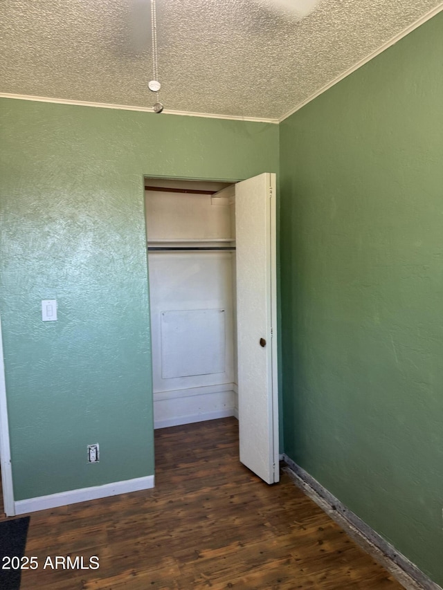 5363 N Black Canyon Highway, Phoenix, AZ 85015 - unfurnished bedroom featuring a closet, a textured wall, a textured ceiling, crown molding, and wood finished floors