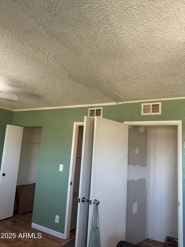 5363 N Black Canyon Highway, Phoenix, AZ 85015 - unfurnished bedroom featuring a textured ceiling, wood finished floors, a closet, and visible vents