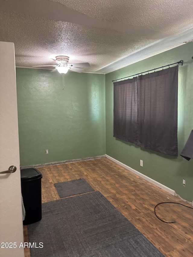 5363 N Black Canyon Highway, Phoenix, AZ 85015 - spare room featuring a textured ceiling, wood finished floors, baseboards, and a ceiling fan