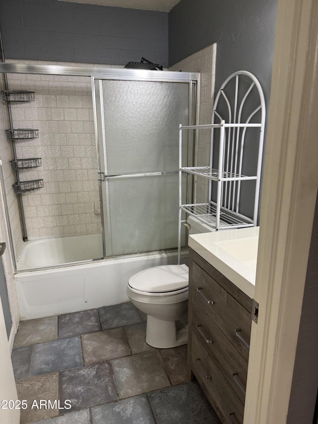 5363 N Black Canyon Highway, Phoenix, AZ 85015 - full bath featuring stone finish flooring, shower / bath combination with glass door, vanity, and toilet