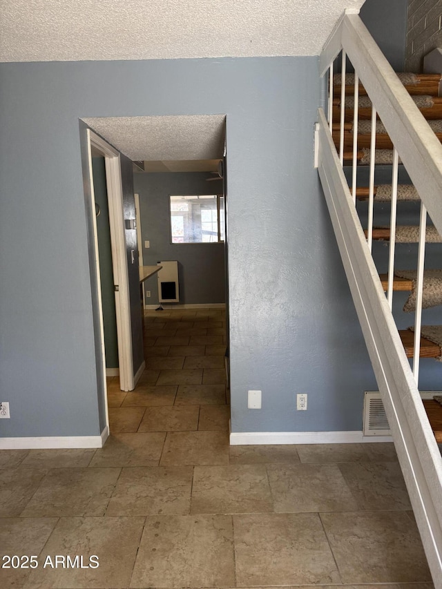 5363 N Black Canyon Highway, Phoenix, AZ 85015 - stairs featuring a textured ceiling, baseboards, and visible vents