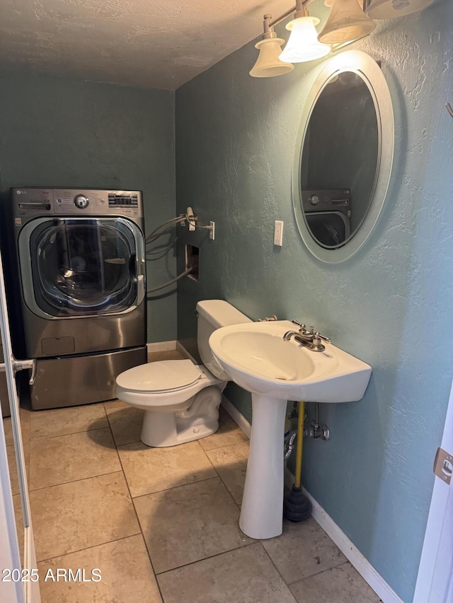 5363 N Black Canyon Highway, Phoenix, AZ 85015 - bathroom featuring tile patterned flooring, washer / dryer, baseboards, and toilet