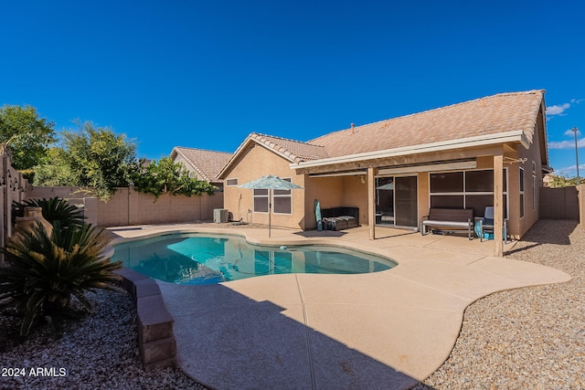 view of pool with central AC unit and a patio