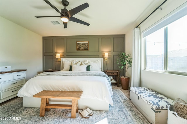 bedroom with ceiling fan and multiple windows