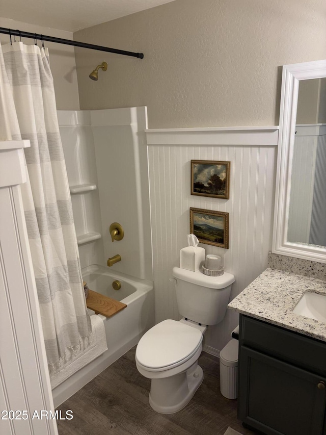 full bathroom with hardwood / wood-style floors, toilet, vanity, and shower / bathtub combination with curtain