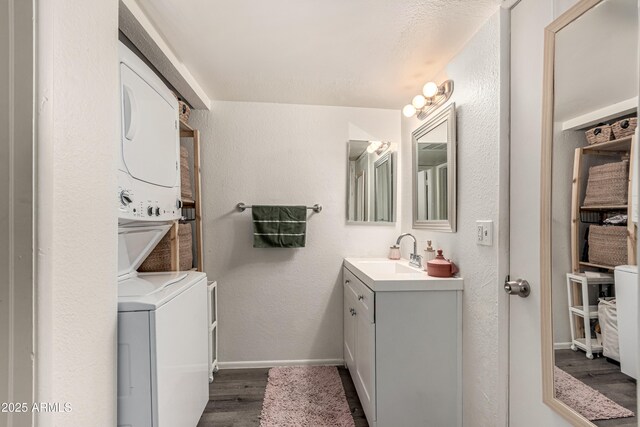 461 W Holmes Ave Unit 350, Mesa, AZ 85210 - bathroom featuring stacked washer / dryer, vanity, and wood finished floors