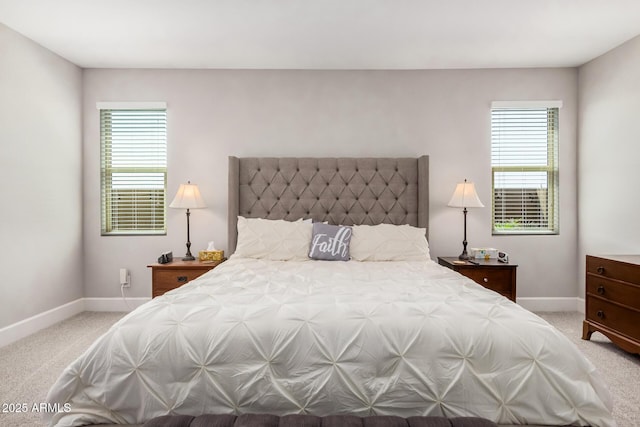 bedroom featuring light carpet and baseboards