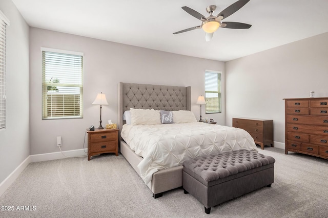 carpeted bedroom featuring a ceiling fan and baseboards