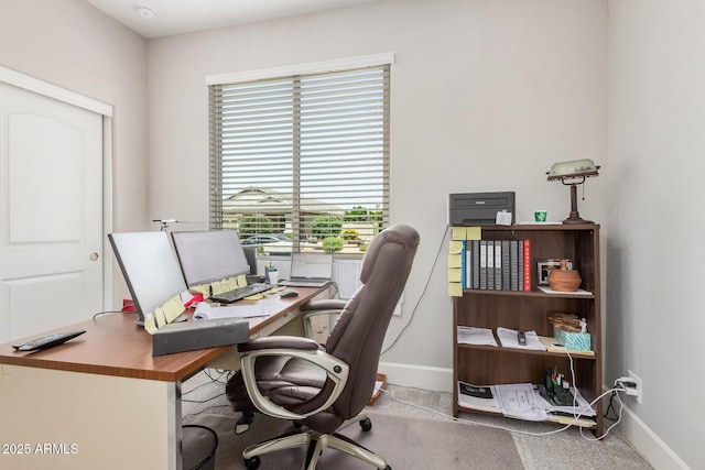 home office featuring baseboards and carpet