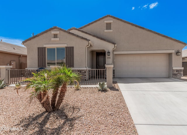 ranch-style house featuring concrete driveway, an attached garage, fence, and stucco siding