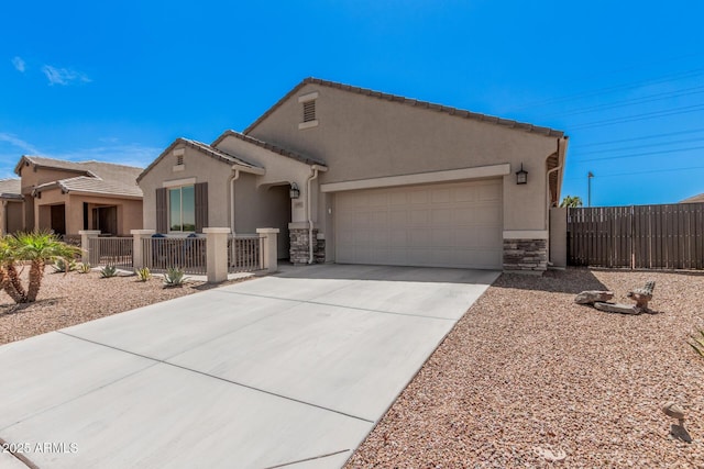 ranch-style house featuring driveway, stone siding, fence, a garage, and stucco siding