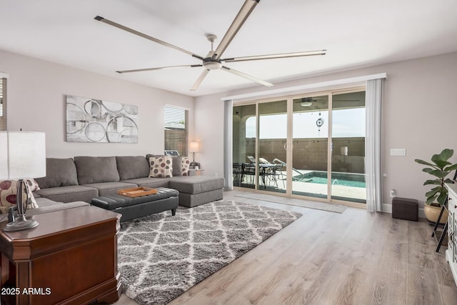 living room with wood finished floors and a ceiling fan