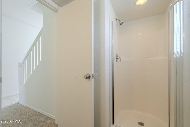 bathroom featuring a stall shower and baseboards