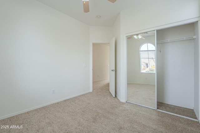 unfurnished bedroom with a closet, carpet flooring, a ceiling fan, and baseboards