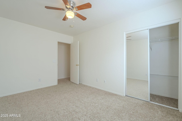 unfurnished bedroom with baseboards, a closet, a ceiling fan, and carpet flooring